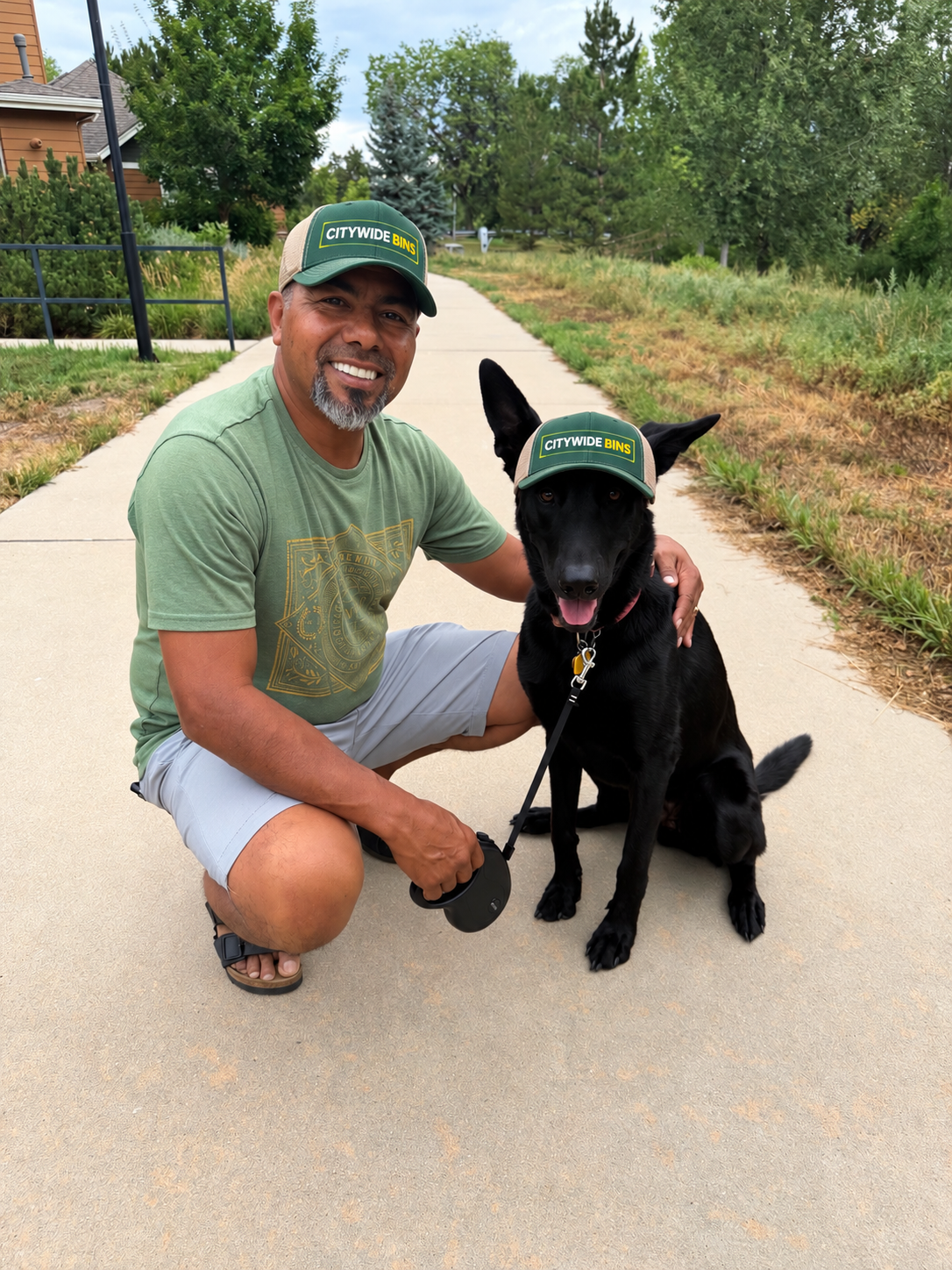 Carlos Mendez, owner of Citywide Bins, pictured with a dog outdoors.
